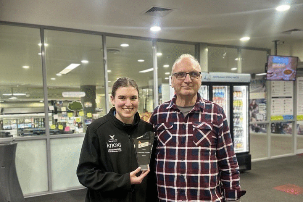 Staff Member and Member stand smiling in Knox Leisureworks foyer